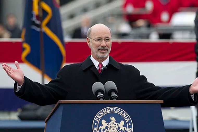 Tom Wolf extends his arms to the crowd as he walks to the podium after being sworn in as Pennsylvania's 47th governor in a noontime ceremony on the east side of the State Capitol Building on Jan 20, 2015. ( CHARLES FOX / Staff Photographer )