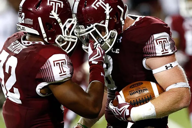 Temple Owls defensive back Will Hayes (32) celebrates the interception by linebacker Tyler Matakevich (right) in the second half at Nippert Stadium. Temple won 34-26.