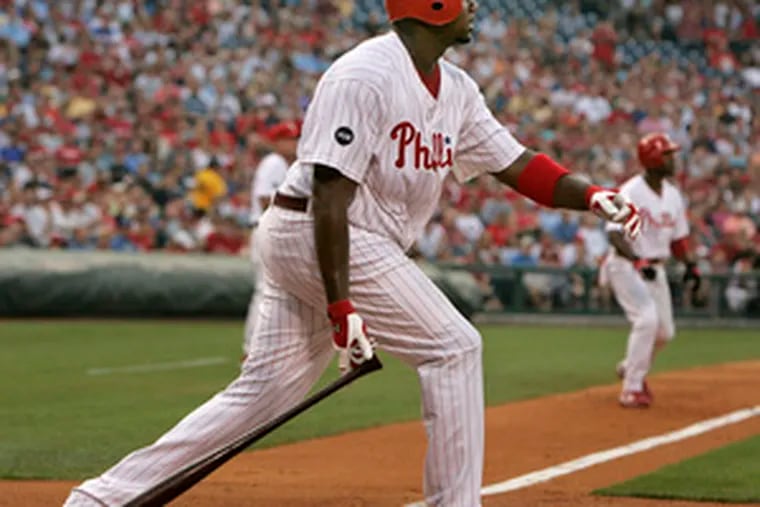 The Phillies&#0039; Ryan Howard watches his home run against the Reds in last night&#0039;s first inning. The two-run shot drove in Jimmy Rollins on third.