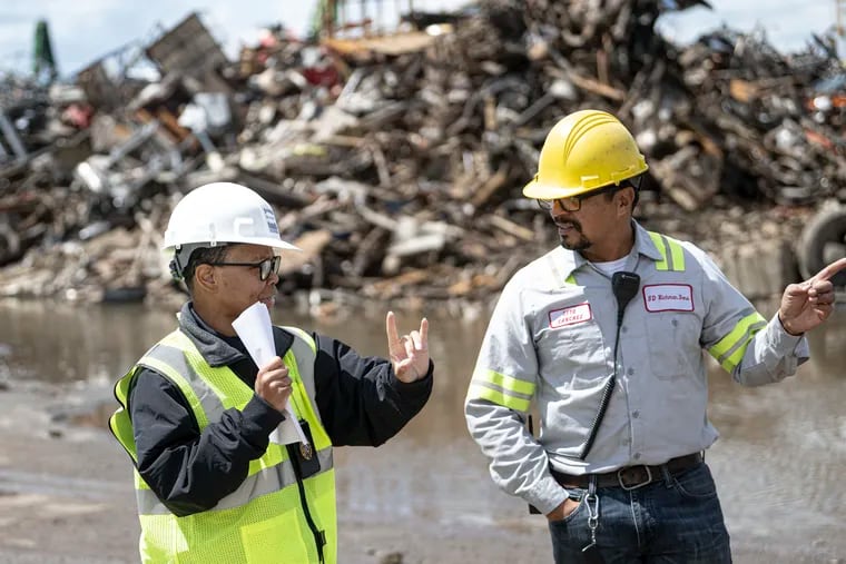 Natasha Lee, a code enforcement inspector, and Otto Sanchez of S.D. Richman Sons speak about procedures and protocols for a junkyard inspection.
