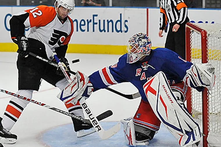 Simon Gagne tries to score past Rangers Henrik Lundqvist during the first period. The Rangers beat the Flyers 3-1. (AP Photo/Kathy Kmonicek)