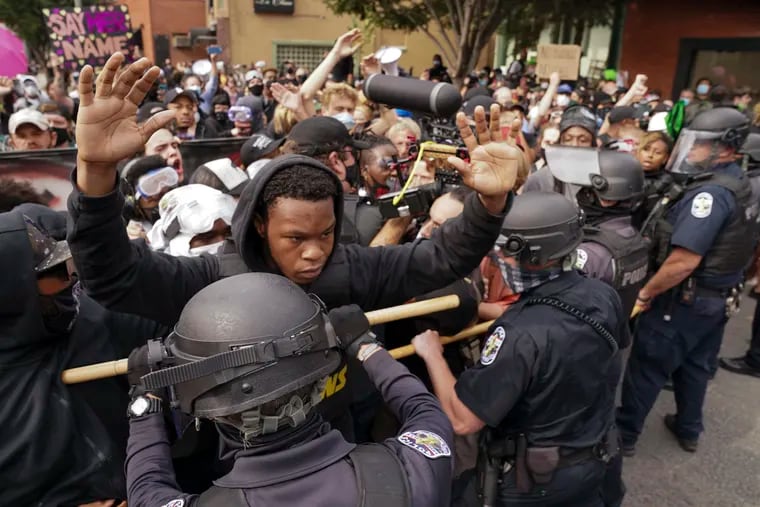 Police and protesters converge during a demonstration on Wednesday, Sept. 23, 2020, in Louisville, Ky.