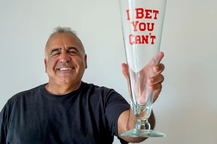 Sammy Best displays one of the few novelty items – an oversized large beer glass – he still has from the Fun Shop owned by his parents.