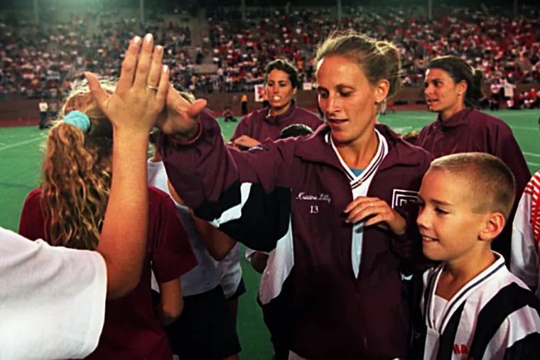 Yes, that's Kristine Lilly in a Temple jacket. A few months after the U.S. won the 1999 World Cup, she came to Philadelphia with Julie Foudy and Mia Hamm (in the background) for a soccer clinic held before a Temple football game at Franklin Field.