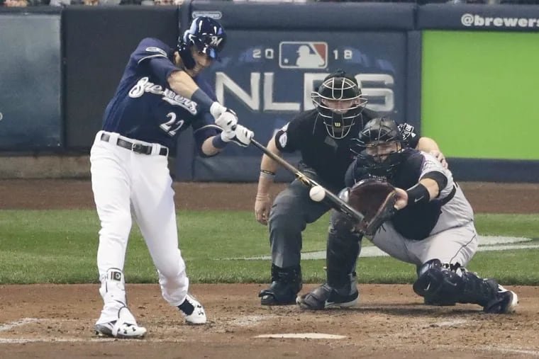 Christian Yelich hits a two-run home run in Game 1 of the National League division series against the Rockies.