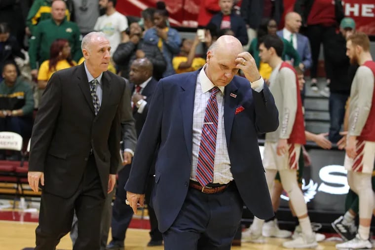 Coach Phil Martelli, center, of St. Joseph's walks off the court after their 85-60 loss to George Mason on Jan. 3, 2019.