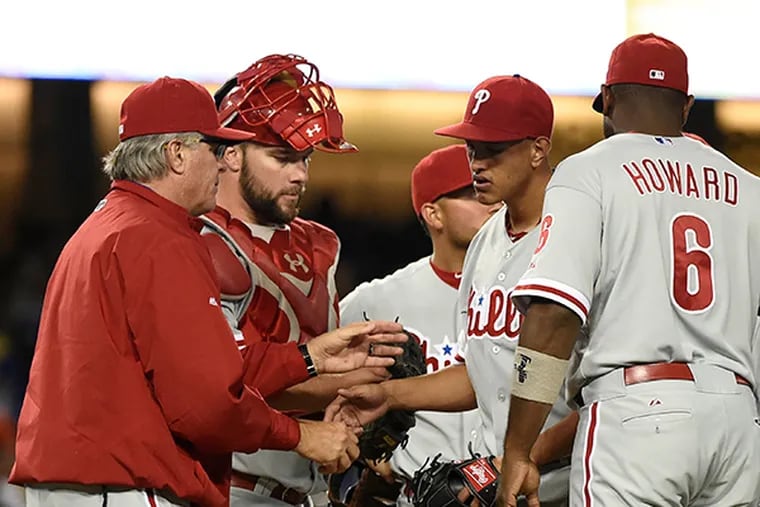 Phillies interim manager Pete Mackanin (45) replaces Philadelphia Phillies starting pitcher Severino Gonzalez (52) against the Los Angeles Dodgers in the sixth inning at Dodger Stadium.