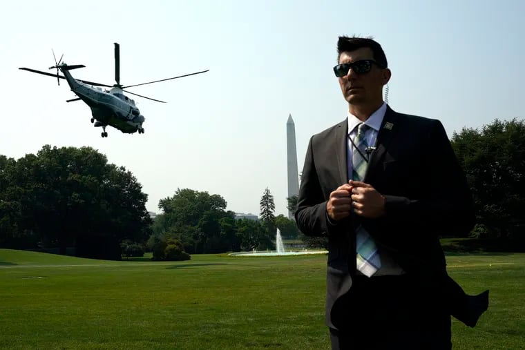 U.S. Secret Service stands guard as the Marine One helicopter with President Joe Biden on board departs the White House en route to Chicago on Wednesday, July 7, 2021. The chief of the Secret Service, James Murray, has delayed his exit while the Secret Service is under scrutiny by the Jan. 6 House committee.