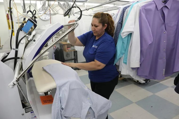 Imelda Abeja touches up a shirt while using a hot press at the CD One Price Cleaners on March 21, 107 in Countryside, Ill. (Antonio Perez/Chicago Tribune/TNS)