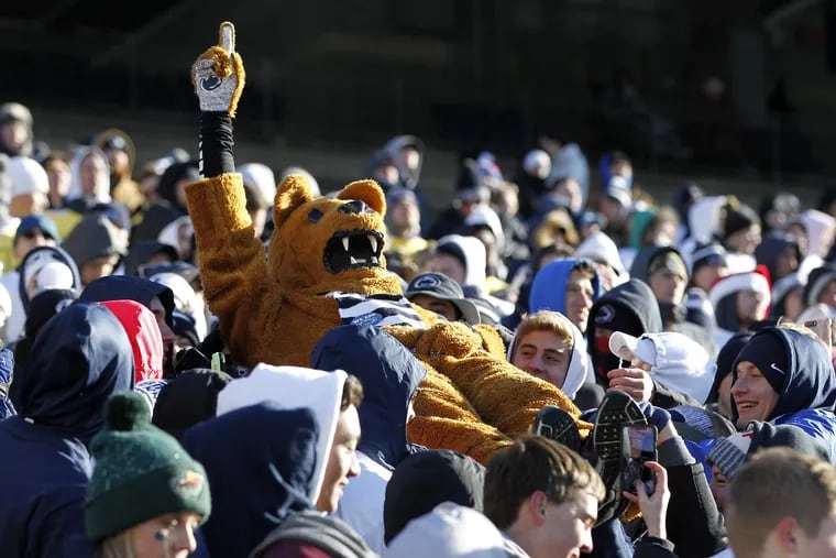 The Nittany Lion mascot takes a ride through the student section.