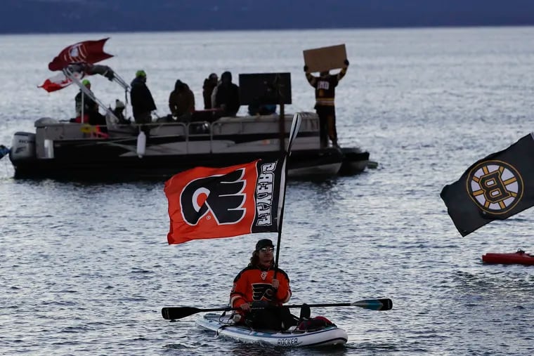 A Flyers fan holds his team's flag while chilling out on Lake Tahoe on Sunday.