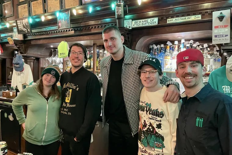 Nikola Jokic with McGillin's bar staff on Tuesday after the Nuggets' loss to the Sixers.