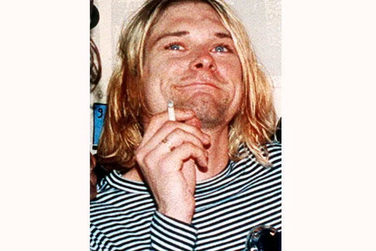 FILE - This 1993 file photo shows Kurt Cobain, the lead singer of the rock band Nirvana. On Friday, April 5, 2019, people gathered throughout the day at Viretta Parkin in Seattle, leaving flowers, candles, and written messages on the 25th anniversary of Cobain's death. Cobain, whose band Nirvana rose to global fame amid Seattle's grunge rock years of the early 1990s, shot himself on April 5, 1994, in his home near Lake Washington.
