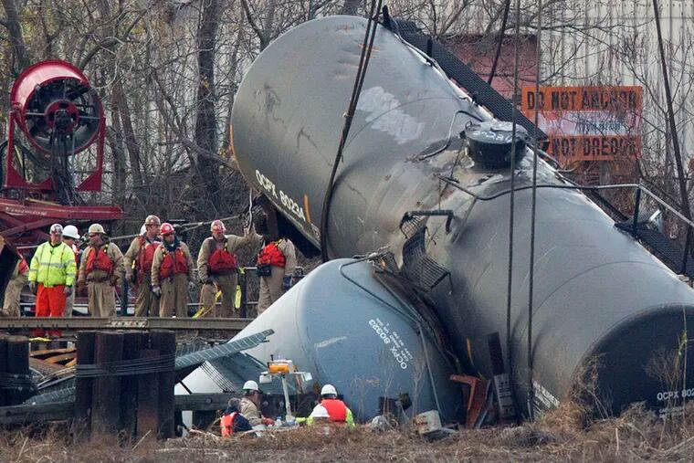 Work crews prepared to hoist the derailed tanker cars from the Mantua Creek in Paulsboro on Dec. 12.
