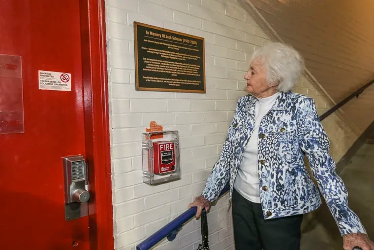 Jean Scheuer, wife of late journalist Jack Scheuer, looks at locker room with a plaque in his honor the Big 5's 2021-22 awards banquet at The Palestra.