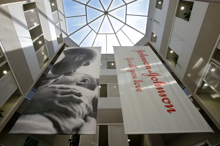 Large banners hang in an atrium at the headquarters of Johnson & Johnson in New Brunswick, N.J., Tuesday, July 30, 2013.