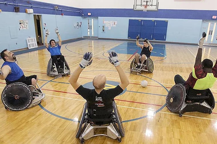 Members of the Akron Rhinos quad rugby team stretch before practice at Weaver Learning Center in Tallmadge, Ohio, on January 17, 2014. (Phil Masturzo/Akron Beacon Journal/MCT)