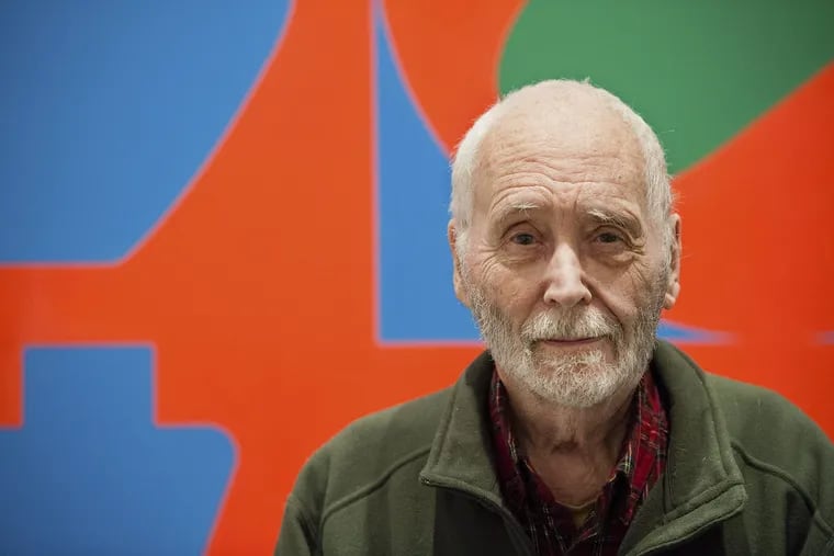 In this Sept. 24, 2013, file photo, artist Robert Indiana, known for his LOVE artwork, poses in front of that painting at New York's Whitney Museum of American Art.