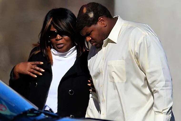 Dallas Cowboys football player Josh Brent, right, arrives, embracing an unidentified person at a memorial service for teammate Jerry Brown. (Tony Gutierrez/AP)