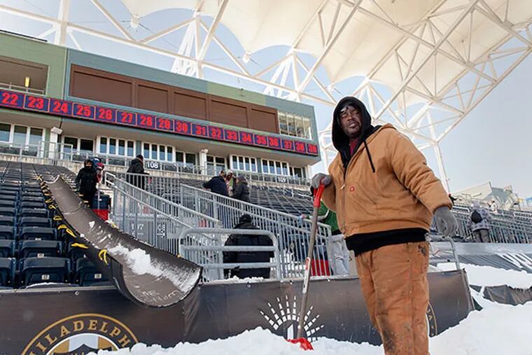 Lawrence McBride scrambles to get the state-of-the-art, 18,500 - seat Major League Soccer PPL Park Stadium in Chester, Pa. ready on time as the snowstorm came just two days before the Philadelphia Union's home opener. (Chanda Jones/Staff Photographer)