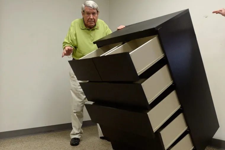 Bobby Puett, president of Diversified Testing Labs, watches as the Ikea Malm six-drawer dresser falls over during a tipover test.
