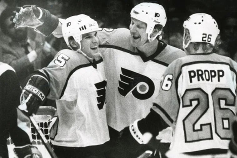 Tim Kerr (center), the Flyers' third all-time leading goal scorer, was selected by San Jose in the 1991 expansion draft and immediately dealt to the Rangers. Here, he celebrates with Peter Zezel (left) and Brian Propp.