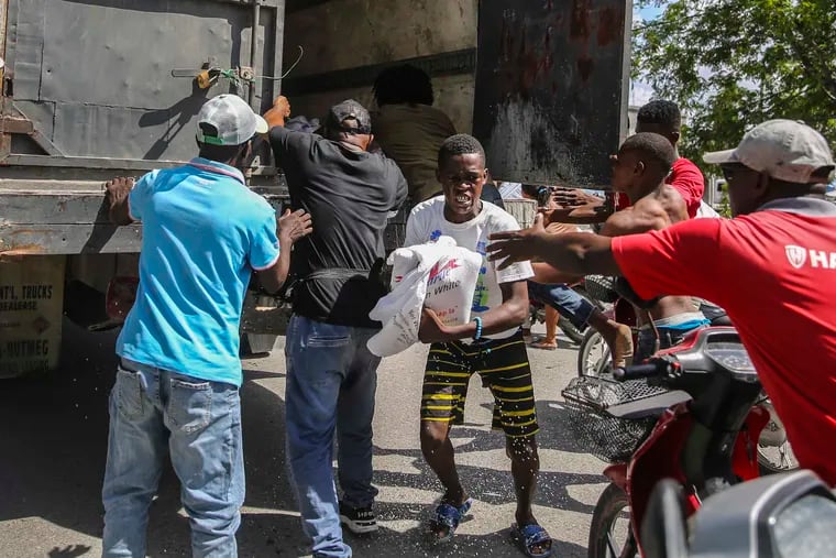 Rice is distributed to residents in Les Cayes, Haiti, on Monday, two days after a 7.2-magnitude earthquake struck the southwestern part of the hemisphere's poorest nation.
