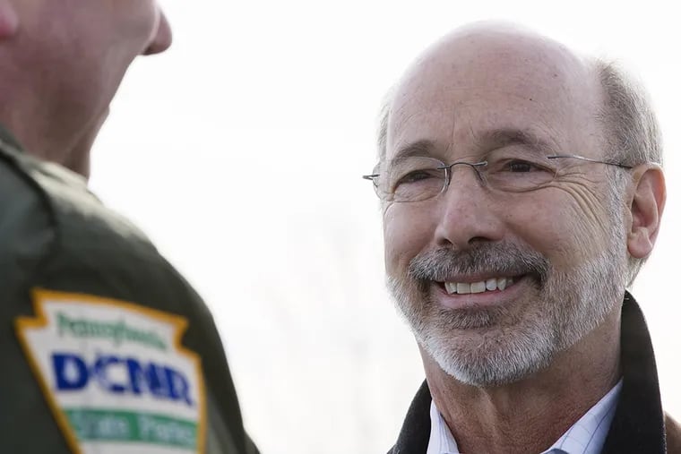 Gov. Tom Wolf, right, speaks with Eric Ihlein, a park manager with the Department of Conservation and Natural Resources, before he signs an executive order Thursday, Jan. 29, 2015, at Benjamin Rush State Park in Philadelphia. (AP Photo/Matt Rourke)