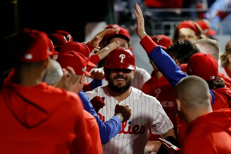 Philadelphia Phillies left fielder Kyle Schwarber celebrates a first inning homer in the dug out in Game 3 of the baseball National League Championship Series against the San Diego Padres, Friday, Oct. 21, 2022, in Philadelphia.