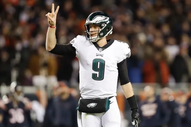 Eagles quarterback Nick Foles raises his fingers for a two-point conversion attempt against the Chicago Bears.