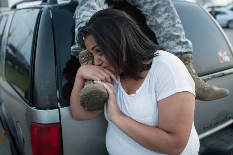 Lucy Hamlin and her husband, Spc. Timothy Hamlin, wait for permission to re-enter the Fort Hood military base, where they live, following a shooting on the base, Wednesday, April 2, 2014, in Fort Hood, Texas. (AP Photo/ Tamir Kalifa)