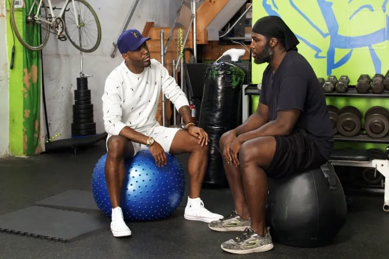 Bodyrock Bootcamp owner Nate McIntyre (right) with "Queer Eye" star Karamo Brown in a scene from the new season of the Netflix series.