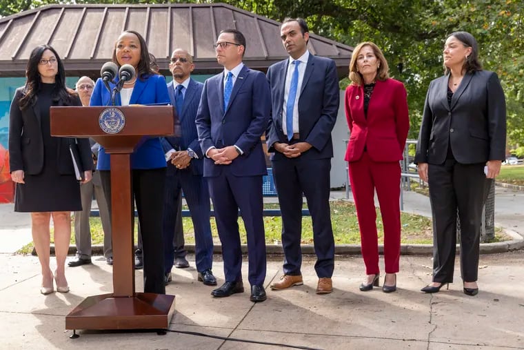Kristen Clarke, at podium, Assistant Attorney General for the Justice Department's Civil Rights Division, is joined with, from left, New Jersey First Assistant Attorney General Lyndsay Ruotolo, Pennsylvania state Sen. Vincent Hughes, Pennsylvania Attorney General Josh Shapiro, Rohit Chopra, CFPB Director, Delaware Attorney General Kathy Jennings and Jacqueline C. Romero, United States Attorney for the Eastern District of Pennsylvania during a press conference at Malcolm X Park in July.