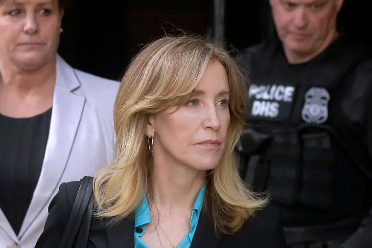 FILE - In this April 3, 2019 file photo, actress Felicity Huffman arrives at federal court in Boston to face charges in a nationwide college admissions bribery scandal. In a court filing on Monday, April 8, 2019, Huffman agreed to plead guilty in the cheating scam. (AP Photo/Steven Senne, File)