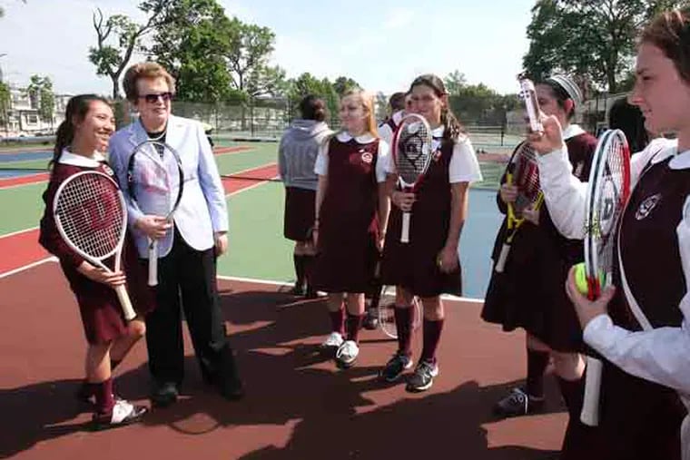 Former Tennis champ Billie Jean King takes a picture Nhu Nguyen, 10th grader with Casey Brown 9th grade taking the photo with members of the Little Flower School after the dedication in Hunting Park of the new tennis courts that her Philadelphia Freedom tennis team help to fund. King is also funding an after school tennis program for area's kids for its first 3 years. the park was once infamous for drugs and alcohol but King is the 3rd major athlete to help restore the park. Wednesday, May 15, 2013.  (  Steven M. Falk / Staff Photographer )