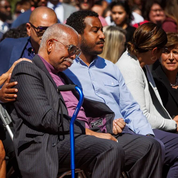 L. Harrison Jay, husband of late JoAnne A. Epps, is consoled during memorial service for his wife.