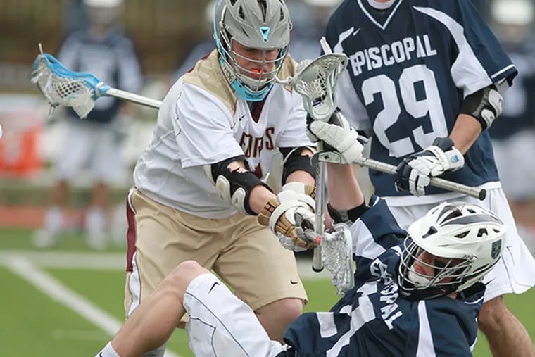 Brian Casey, left, of the Haverford School knocks Gavin Chambers, center, of  Episcopal Academy to the ground during the 2nd quarter of a Inter-Ac lacrosse game on April 7, 2015. (Charles Fox/Staff Photographer)