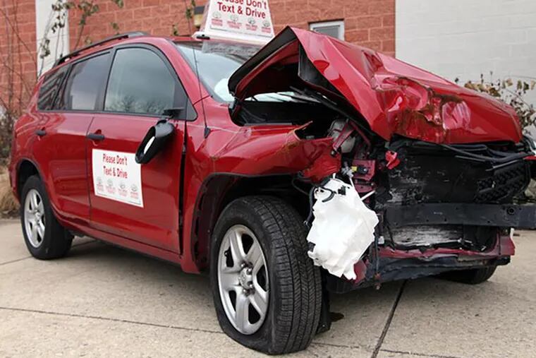 Radnor Police set up a smashed car outside of Radnor High School to warn teens of the dangers of texting and driving. (KELSEY ANNE DUBINSKY/ Staff Photographer)