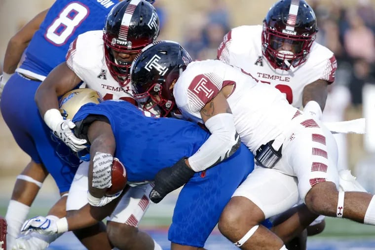 Tulsa’s Angelo Brewer (4) is tackled by Temple defenders during the first half on Saturday.