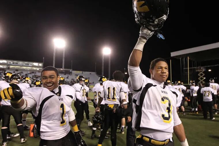 Archbishop Wood's Desmon Peoples (1) and cousin Brandon Peoples (3) lead the celebration after scoring five touchdowns between them to lead the Vikings' rout.