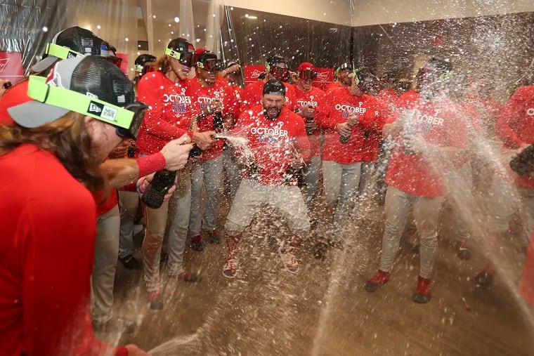 Phillies players celebrate after they beat the St. Louis Cardinals in the National League Wild Card Series on Saturday. They sang a version of Swedish singer Robyn’s ‘Dancing On My Own.’
