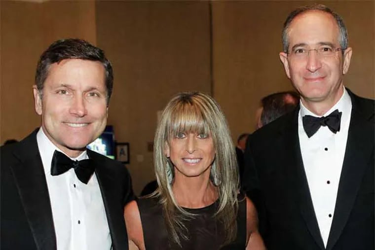 Midas touch: Bonnie Hammer with NBCUniversal head Steve Burke (left) and Comcast CEO Brian Roberts at this year's Golden Globes awards. (Paul Drinkwater / NBC)