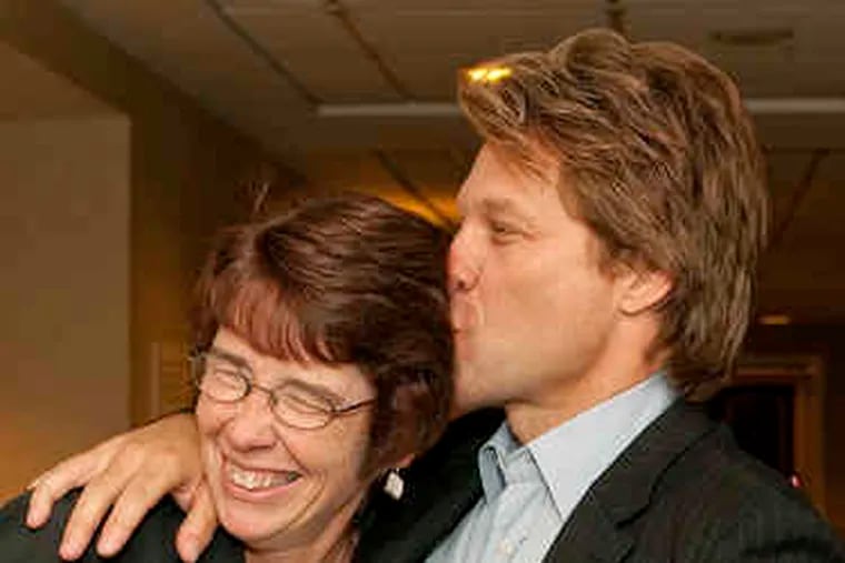 Jon Bon Jovi gives a big kiss of greeting to Sister Mary Scullion of Project HOME, in September 2009. That night, the charity, celebrating its 20th anniversary, gave Bon Jovi its first Golden Heart award.