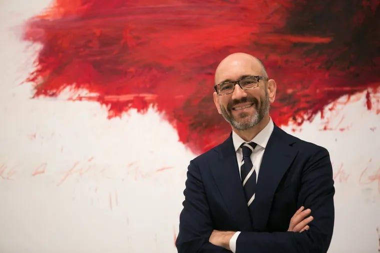 Carlos Basualdo, the contemporary art curator at the Philadelphia Museum of Art, stands in front of a work by Cy Twombly, a portion of Fifty Days at Iliam on exhibit at the museum  MAGGIE LOESCH / Staff Photographer