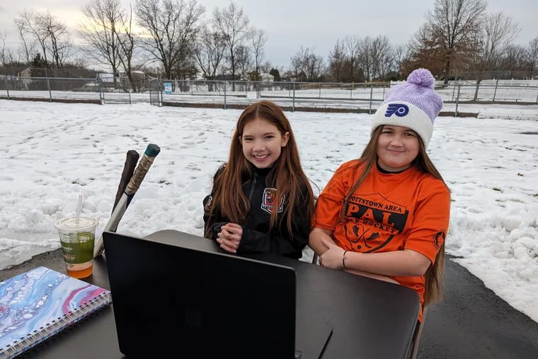 Natalie Van Druff (left) and Lilly Walter of Gilbertsville are working to repair their local hockey rink.