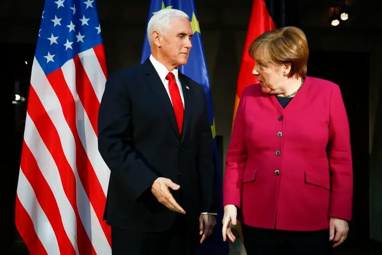 German Chancellor Angela Merkel welcomes Vice President Mike Pence for a bilateral meeting during the Munich Security Conference.