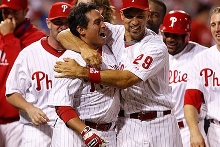 Carlos Ruiz celebrates with Raul Ibanez after his walk-off home run. (Ron Cortes/Staff Photographer)