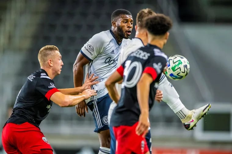 Mark McKenzie, center, scored an 87th minute tying goal in the Union's 2-2 tie at D.C. United.