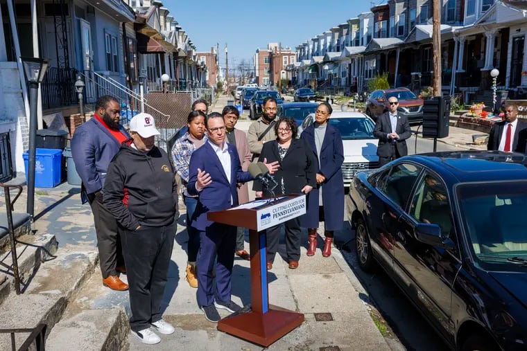 Gov. Josh Shapiro joins local leaders and Philadelphia homeowner Dominque Young outside Young's home in Southwest Philadelphia on Friday to push for $50 million in state funding for the Whole Home Repairs program, which Young benefitted from.