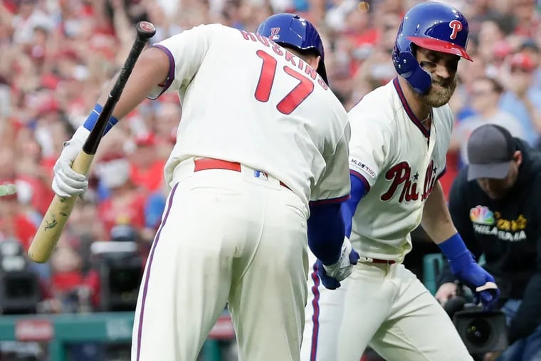 Phillies Bryce Harper celebrates his seventh-inning solo home run with teammate Rhys Hoskins against the Atlanta Braves on Saturday, March 30, 2019 in Philadelphia.